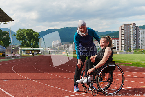 Image of A woman with disability in a wheelchair talking with friend after training on the marathon course