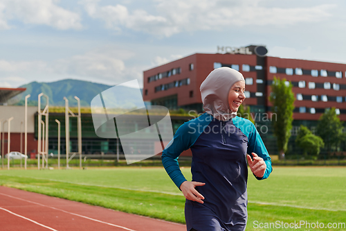 Image of A muslim woman in a burqa sports muslim clothes running on a marathon course and preparing for upcoming competitions