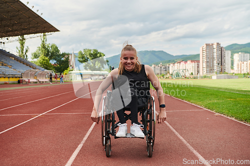 Image of A woman with disablity driving a wheelchair on a track while preparing for the Paralympic Games