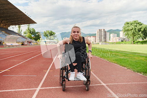 Image of A woman with disablity driving a wheelchair on a track while preparing for the Paralympic Games