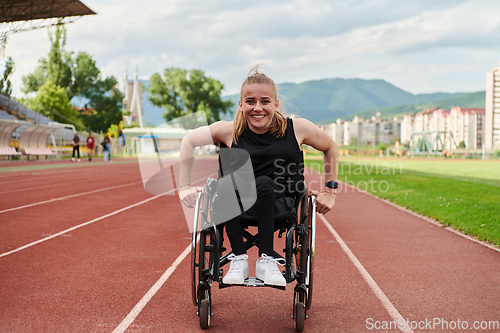 Image of A woman with disablity driving a wheelchair on a track while preparing for the Paralympic Games