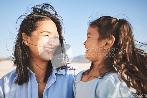 Image of Smile, love and a mother and child at the beach for family, travel or summer freedom. Happy, Bali and a mom with a girl kid at the ocean for a holiday, bonding or together with care at the sea