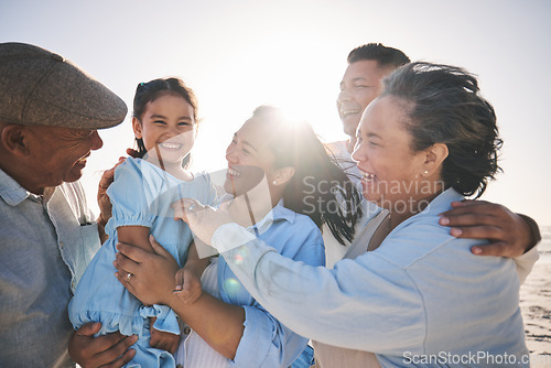 Image of Family, smile and a girl on the beach with her grandparents in summer for holiday or vacation together. Love, sunset or flare with parents, kids and senior people by the ocean or sea for bonding