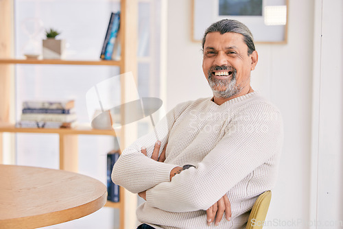 Image of Happy, crossed arms and portrait of a man in the office with confidence and positive attitude. Smile, calm and professional mature male designer sitting on a lunch break in the modern workplace.