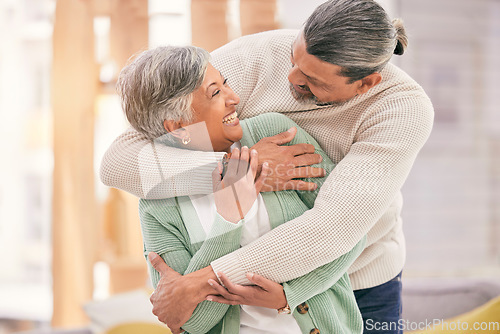 Image of Happy elderly couple, hug and relax with love in living room bonding, romance or embrace together at home. Mature man and woman smile in happiness for loving relationship, affection or commitment