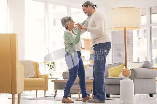 Image of Home, dancing and a happy mature couple on anniversary, birthday or valentines day celebration. Holding hands, love or care of man and woman with healthy marriage, happiness and moving to music