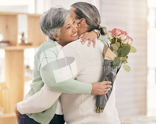 Image of Mature couple, flowers and hug at home for anniversary, birthday or valentines celebration. Surprise, love and roses or bouquet with a man and woman for healthy marriage, happiness and romance