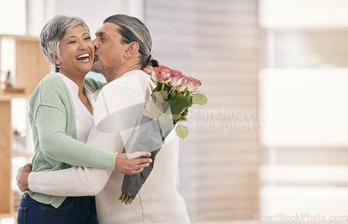 Image of Mature couple, flowers and kiss at home for anniversary, birthday or valentines celebration. Surprise, love and roses bouquet with a man and woman for healthy marriage, happiness and mockup space