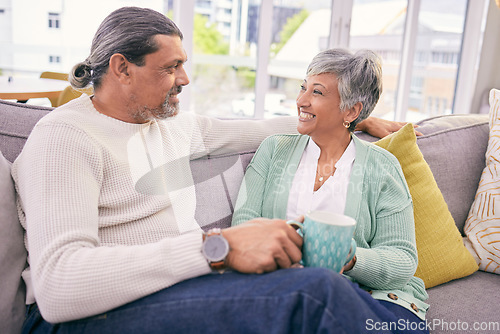 Image of Relax, conversation and mature couple on sofa for bonding, healthy relationship and connection with coffee. Marriage, love and happy man and woman drinking tea on couch in discussion, talking or chat