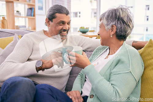 Image of Coffee, talking and mature couple on sofa for bonding, healthy relationship and connection. Marriage, love and happy man and woman drinking tea on couch to relax in discussion, conversation and chat