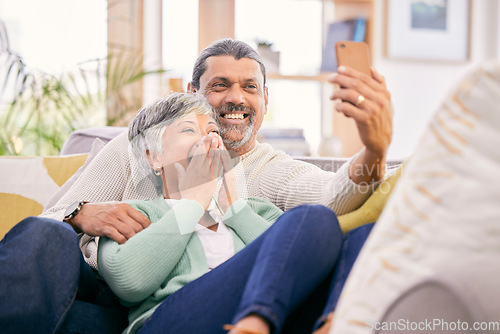 Image of Happy, selfie and a senior couple with a phone on the sofa for communication, social media or a video call. Smile, house and an elderly man and woman taking a photo with a mobile on the couch