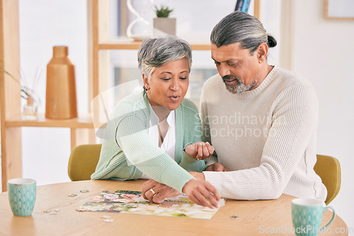 Image of Puzzle, entertainment and happy senior couple in home for bonding, fun activity and relax together. Retirement, love and man and woman with jigsaw game for playing, hobby and connect in living room