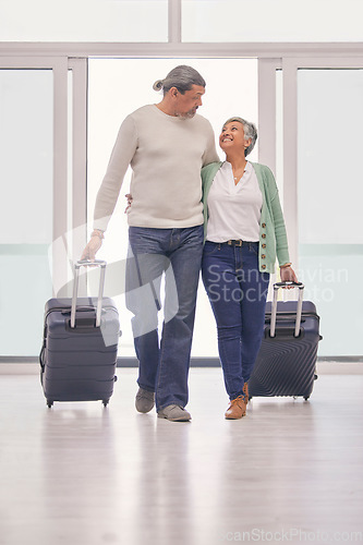 Image of Mature couple, suitcase and walking in airport lobby, happy and travel together on tourist holiday. Man, woman smile and luggage for flight on vacation, immigration journey and global airplane trip