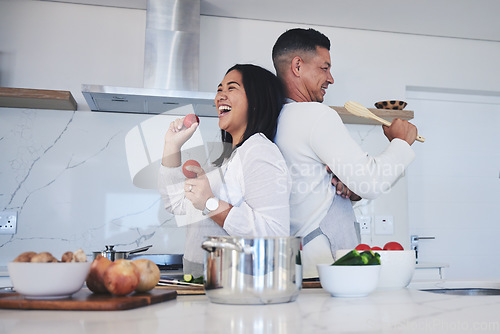Image of Happy couple, food and fun cooking in kitchen together for healthy eating or natural nutrition at home. Man and woman enjoying teamwork or bonding in happiness for breakfast, lunch or supper meal