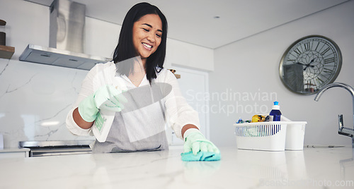 Image of Happy woman, housekeeper and cleaning kitchen table with spray bottle, detergent or bacteria and germ removal at home. Female person maid or cleaner wiping surface with cloth in hygiene or sanitise