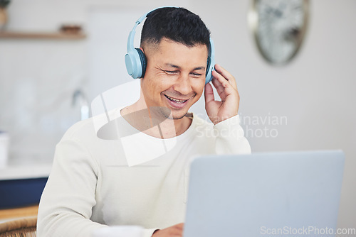 Image of Remote work from home, smile and man with a laptop, headphones and typing with research for a project. Person, employee or copywriter with a pc, lounge or happiness with connection or search internet