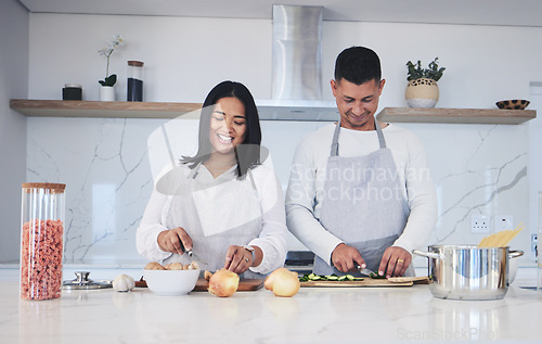 Image of Happy, cooking and love with couple in kitchen for food, health and lunch recipe. Smile, nutrition and dinner with man and woman cutting vegetables at home for diet, wellness and romance together