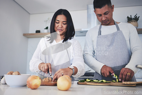 Image of Help, cooking and love with couple in kitchen for food, health and lunch recipe. Happy, nutrition and dinner with man and woman cutting vegetables at home for diet, wellness and romance together