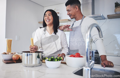 Image of Laughing, cooking and love with couple in kitchen for food, health and lunch recipe. Happy, nutrition and dinner with man and woman and pasta at home for diet, wellness and romance together