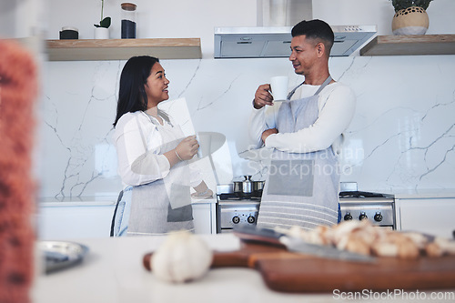 Image of Couple in kitchen, coffee and cooking together with conversation, smile and love in home. Relax, man and woman in bonding discussion, making food for dinner vegetables and drinking tea in apartment.