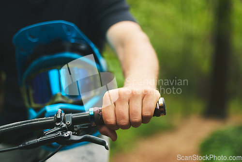 Image of Hand, handle and cycling with helmet, sports and person in forest, mockup space and closeup. Mountain bike, biker outdoor and travel with adventure, fitness and ready to ride, exercise and training