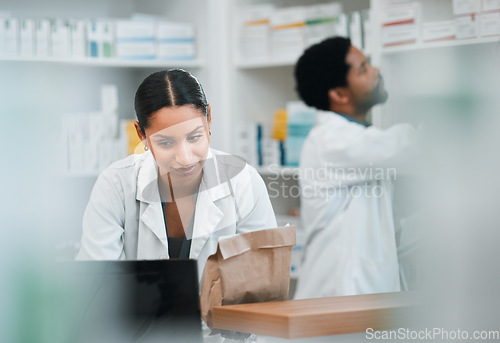 Image of Woman, pharmacist and team in inventory inspection or checking stock or medication at the pharmacy. People, medical or healthcare professional looking at pharmaceuticals together at the drugstore