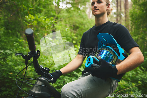 Image of Mountain bike, man and helmet, nature and sports with adventure and fitness in forest. Cycling outdoor, biker and travel with athlete, exercise training and ready to ride, bicycle and challenge