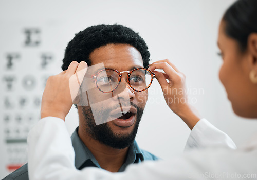 Image of Consulting, wow and optometry with black man and glasses for medical, shopping and help. Healthcare, ophthalmology and eye care with patient and doctor for surprise, advice and lens prescription