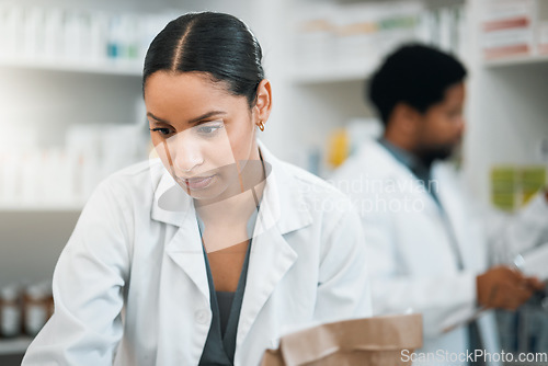 Image of Pharmacy, medicine and inventory with woman in store for retail, pills and product. Shopping, medical and healthcare with pharmacist and stock for prescription, wellness and supplements dispensary