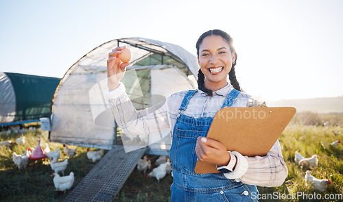 Image of Farm, poultry and a woman with an egg for inspection and a clipboard for quality control. Chicken farming, sustainability and portrait of farmer person with organic produce outdoor for agriculture