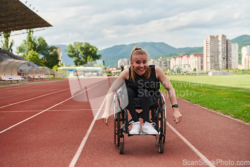 Image of A woman with disablity driving a wheelchair on a track while preparing for the Paralympic Games