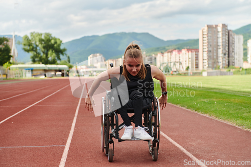 Image of A woman with disablity driving a wheelchair on a track while preparing for the Paralympic Games