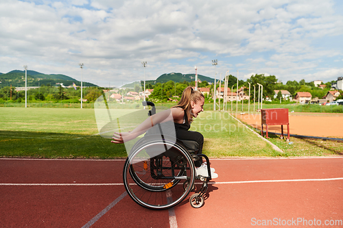 Image of A woman with disablity driving a wheelchair on a track while preparing for the Paralympic Games