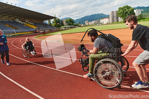 Image of A cameraman filming the participants of the Paralympic race on the marathon course