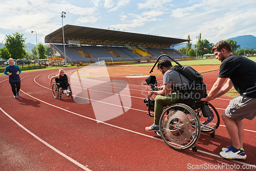 Image of A cameraman filming the participants of the Paralympic race on the marathon course