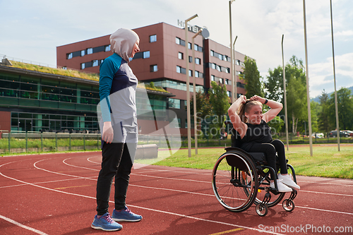 Image of A Muslim woman in a burqa running together with a woman in a wheelchair on the marathon course, preparing for future competitions.