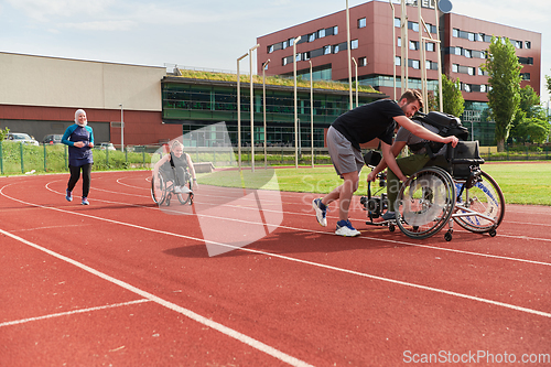 Image of A cameraman filming the participants of the Paralympic race on the marathon course