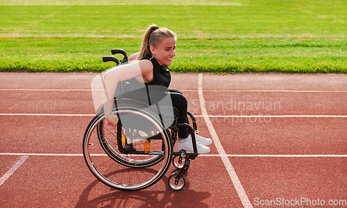 Image of A woman with disablity driving a wheelchair on a track while preparing for the Paralympic Games