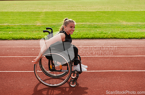 Image of A woman with disablity driving a wheelchair on a track while preparing for the Paralympic Games