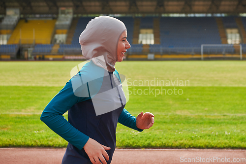 Image of A muslim woman in a burqa sports muslim clothes running on a marathon course and preparing for upcoming competitions