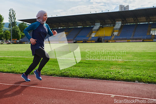 Image of A muslim woman in a burqa sports muslim clothes running on a marathon course and preparing for upcoming competitions