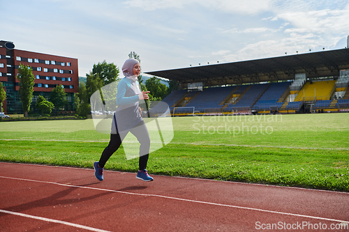 Image of A muslim woman in a burqa sports muslim clothes running on a marathon course and preparing for upcoming competitions