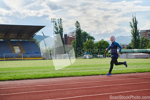 Image of A muslim woman in a burqa sports muslim clothes running on a marathon course and preparing for upcoming competitions