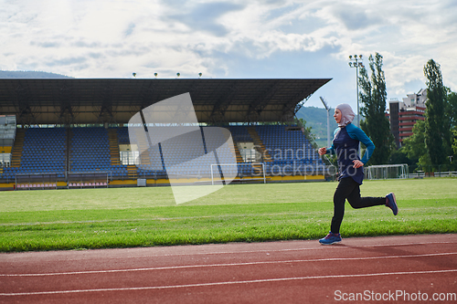 Image of A muslim woman in a burqa sports muslim clothes running on a marathon course and preparing for upcoming competitions