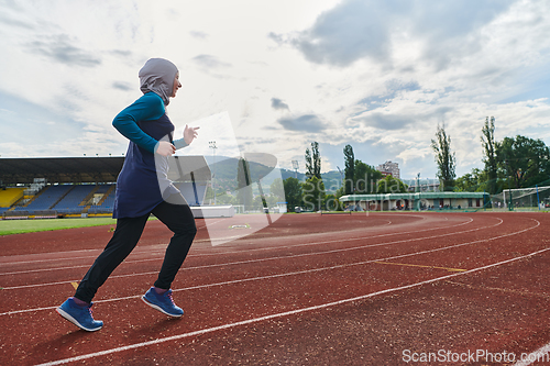 Image of A muslim woman in a burqa sports muslim clothes running on a marathon course and preparing for upcoming competitions