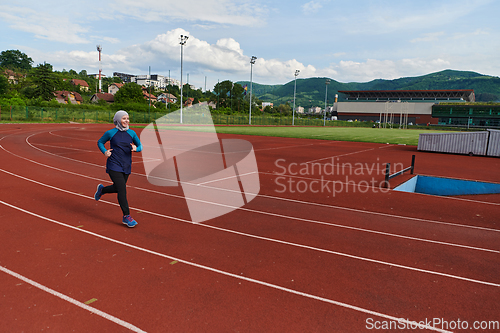 Image of A muslim woman in a burqa sports muslim clothes running on a marathon course and preparing for upcoming competitions