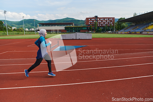 Image of A muslim woman in a burqa sports muslim clothes running on a marathon course and preparing for upcoming competitions