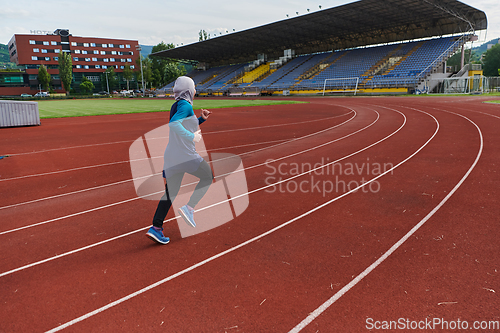 Image of A muslim woman in a burqa sports muslim clothes running on a marathon course and preparing for upcoming competitions