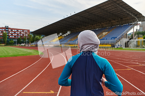 Image of A muslim woman in a burqa sports muslim clothes running on a marathon course and preparing for upcoming competitions