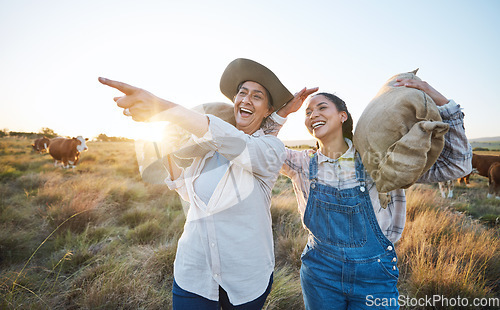 Image of Hand pointing, happy and women on a farm for sustainability, agro and cattle farming together. Farmer, team female friends in a field for agriculture, eco friendly and livestock, cow or animal check